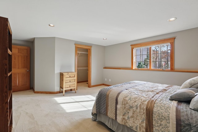 bedroom with light carpet, recessed lighting, a closet, baseboards, and a spacious closet