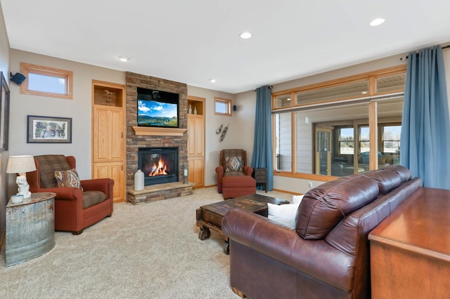 carpeted living area with recessed lighting and a fireplace