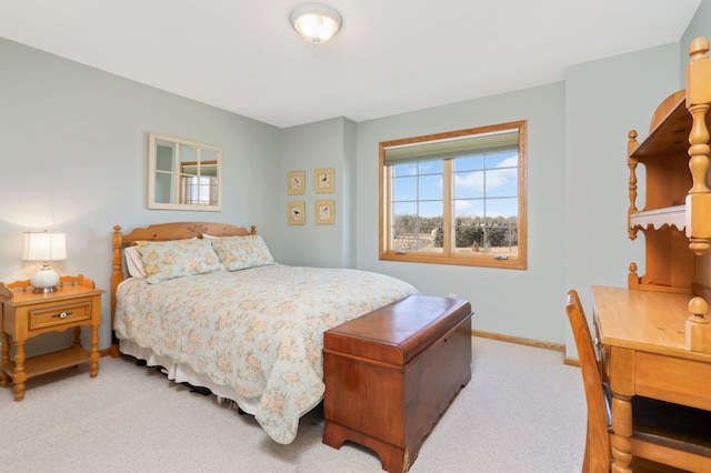 bedroom featuring light colored carpet and baseboards