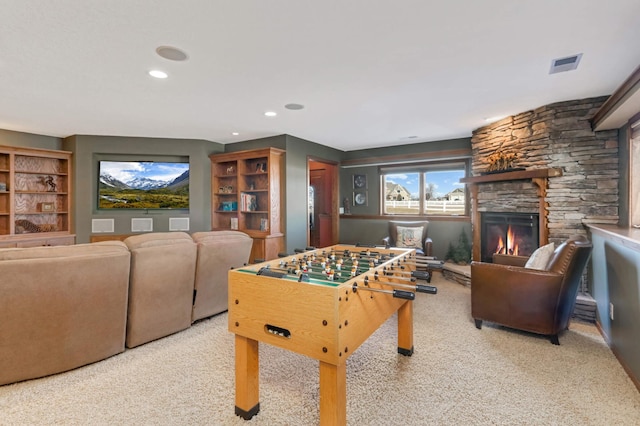 recreation room featuring recessed lighting, carpet flooring, a fireplace, and visible vents