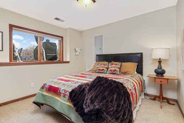 carpeted bedroom with visible vents and baseboards