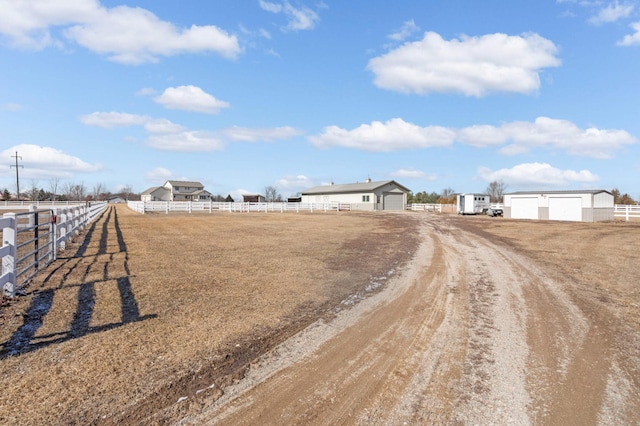 view of road featuring a rural view and dirt driveway