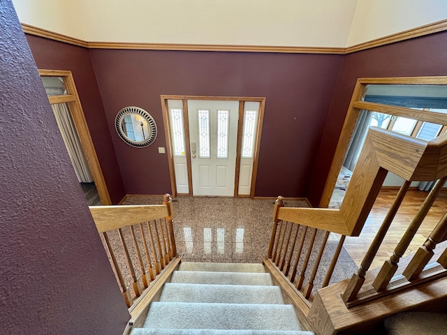 entrance foyer with baseboards, stairs, and granite finish floor