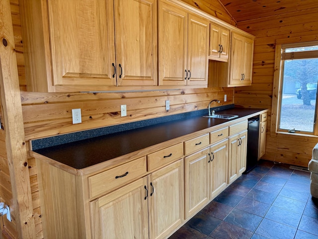 kitchen with dishwashing machine, wooden walls, lofted ceiling, a sink, and dark countertops