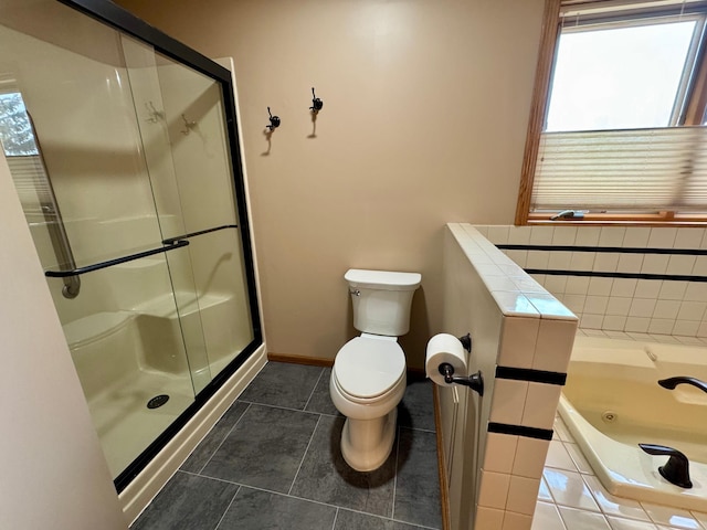 bathroom featuring toilet, a stall shower, and a wealth of natural light