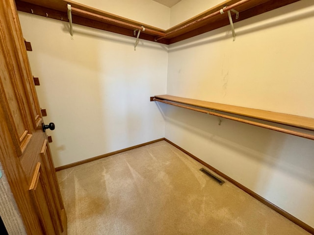 spacious closet with visible vents and carpet flooring