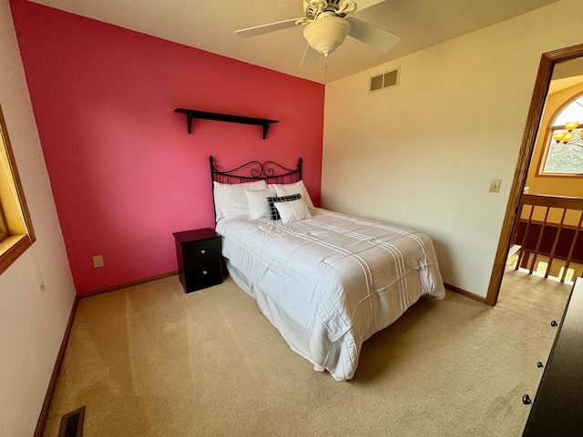 bedroom featuring visible vents, baseboards, carpet, and a ceiling fan