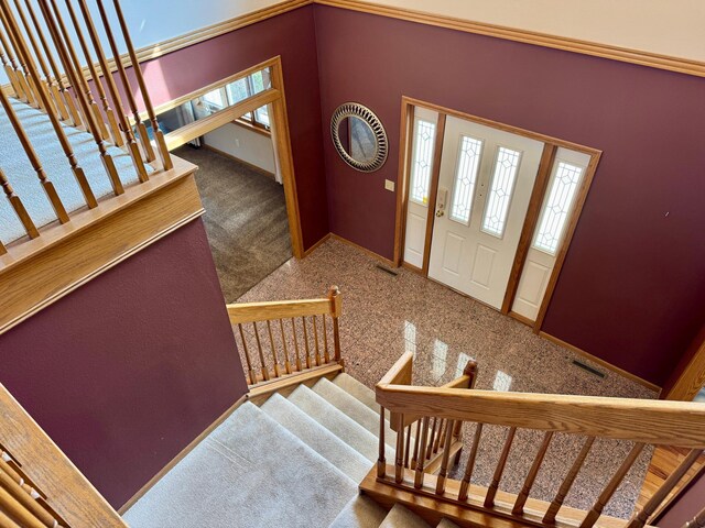 entryway with visible vents, baseboards, and stairs