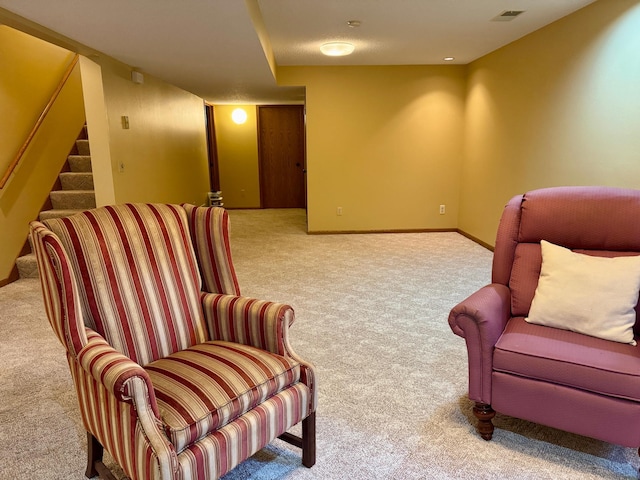 living area featuring visible vents, carpet flooring, stairway, and baseboards