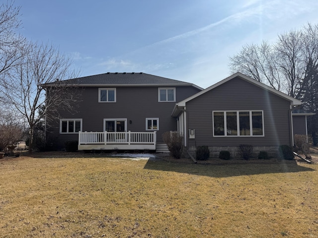 rear view of house featuring a yard and a deck