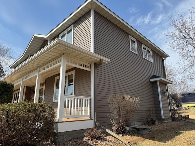 view of side of property with covered porch