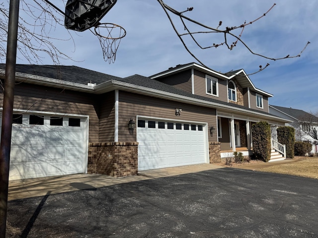 view of front facade with a porch, an attached garage, and driveway