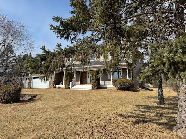 view of property hidden behind natural elements with a front lawn and an attached garage