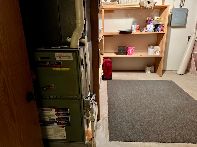 utility room featuring electric panel and heating unit