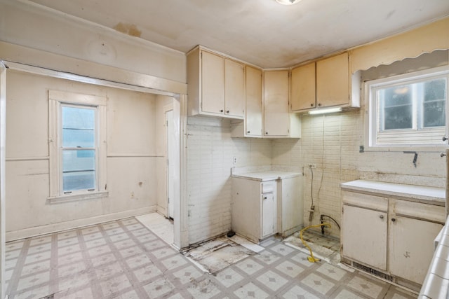 kitchen featuring light countertops, light floors, and a wealth of natural light