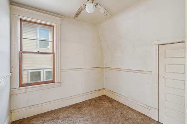 unfurnished room featuring a wealth of natural light, carpet, and ceiling fan