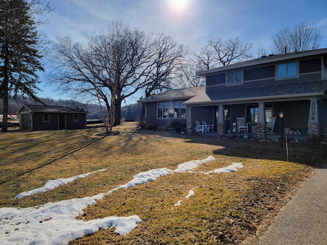 view of yard with covered porch and an outdoor structure