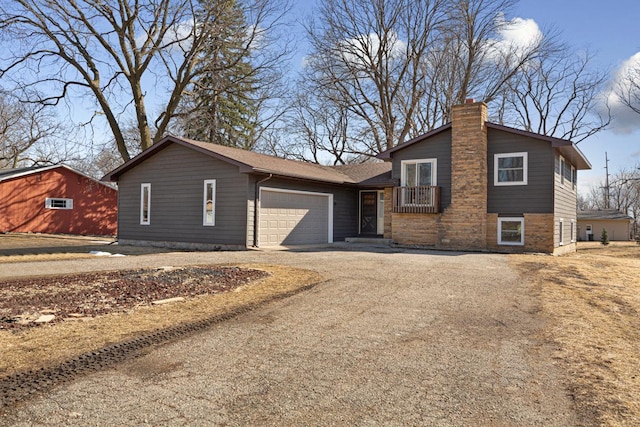 split level home with a chimney, a garage, and dirt driveway