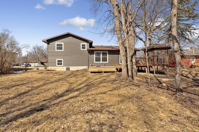 rear view of house with a wooden deck