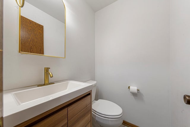 bathroom with toilet and vanity