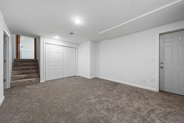 unfurnished bedroom featuring carpet, visible vents, baseboards, recessed lighting, and a closet