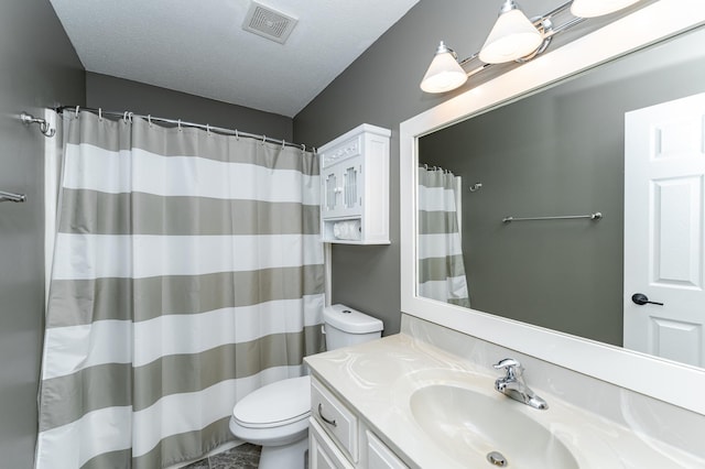 bathroom with visible vents, curtained shower, toilet, vanity, and a textured ceiling