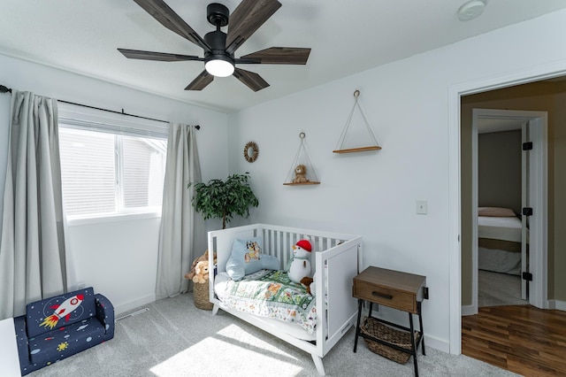 carpeted bedroom featuring a ceiling fan and baseboards