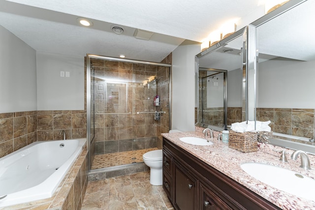 bathroom featuring double vanity, a tub with jets, a stall shower, and a sink