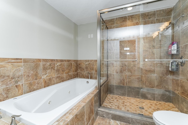 full bathroom with a whirlpool tub, a shower stall, and toilet