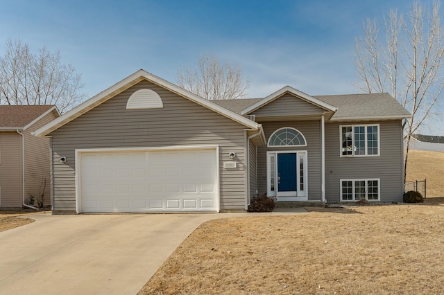 view of front facade with a garage and concrete driveway