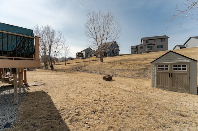 view of yard with an outdoor structure and a shed