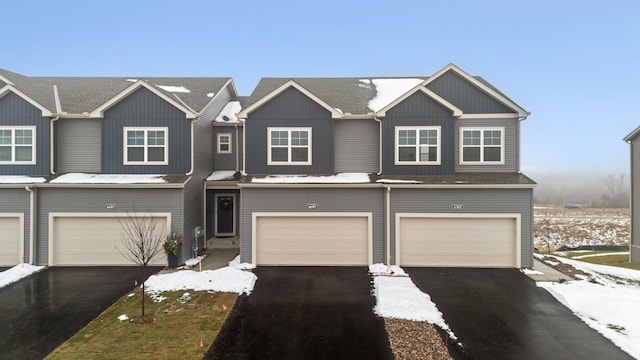 view of property with driveway and a garage