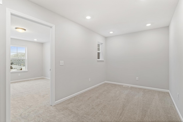 spare room with recessed lighting, baseboards, and carpet