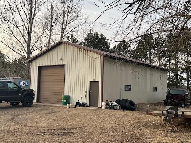 view of outbuilding featuring an outdoor structure and driveway