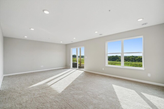 unfurnished room with recessed lighting, baseboards, and carpet floors