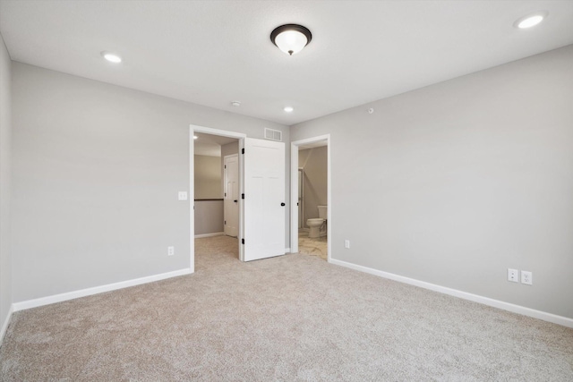 unfurnished bedroom with baseboards, visible vents, carpet floors, recessed lighting, and connected bathroom