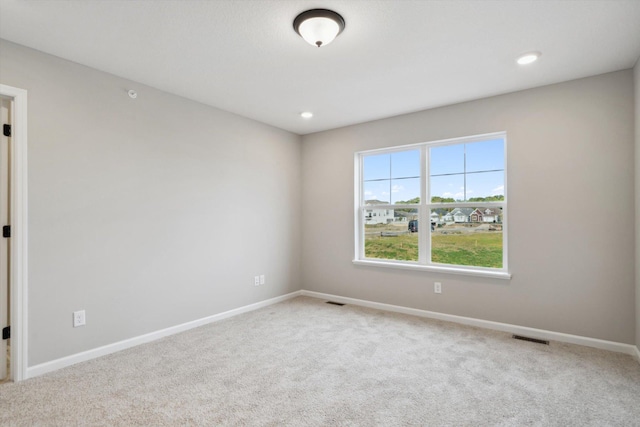 carpeted empty room featuring recessed lighting, baseboards, and visible vents