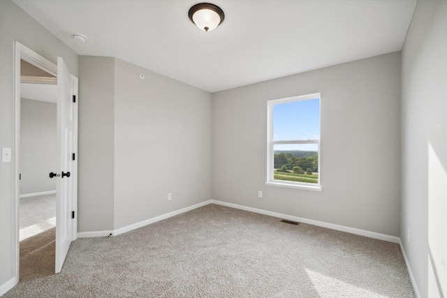 unfurnished room featuring visible vents, baseboards, and carpet