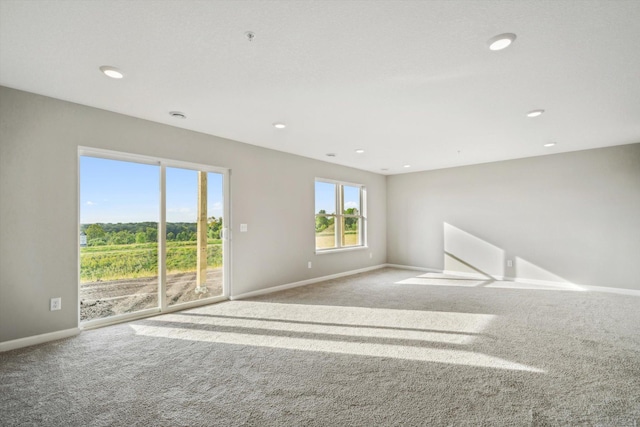 carpeted empty room with recessed lighting and baseboards