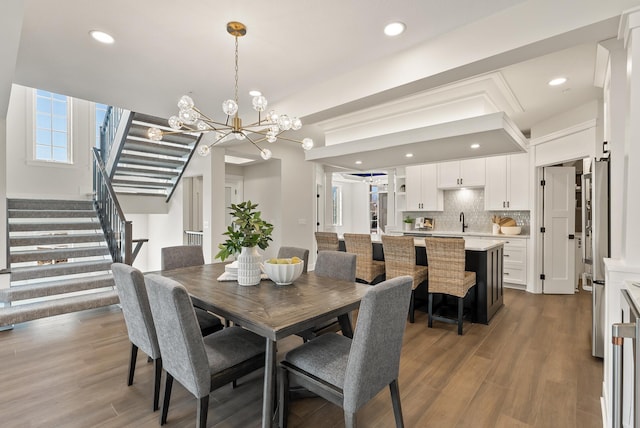 10814 Falling Water Ln Unit D, Woodbury, MN 55129 - dining area featuring a chandelier, stairway, wood finished floors, and recessed lighting