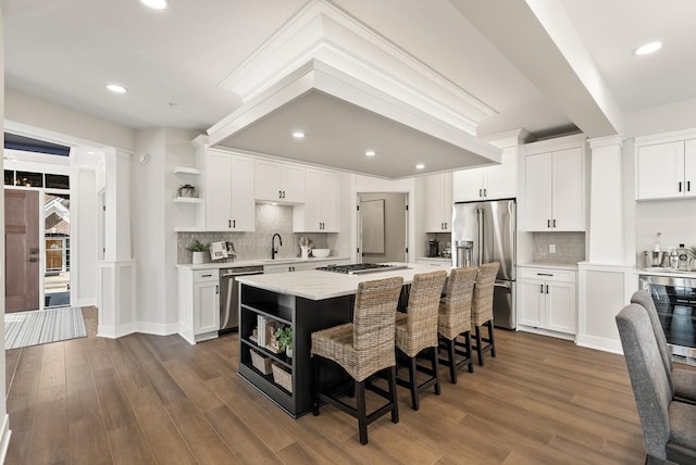 10814 Falling Water Ln Unit D, Woodbury, MN 55129 - kitchen featuring open shelves, appliances with stainless steel finishes, a sink, white cabinetry, and a kitchen island