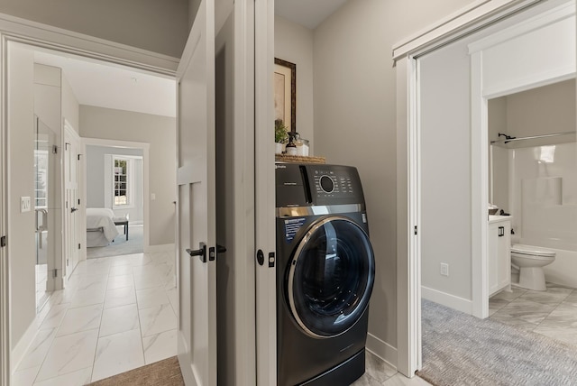 10814 Falling Water Ln Unit D, Woodbury, MN 55129 - washroom featuring washer / clothes dryer, light marble finish flooring, and baseboards
