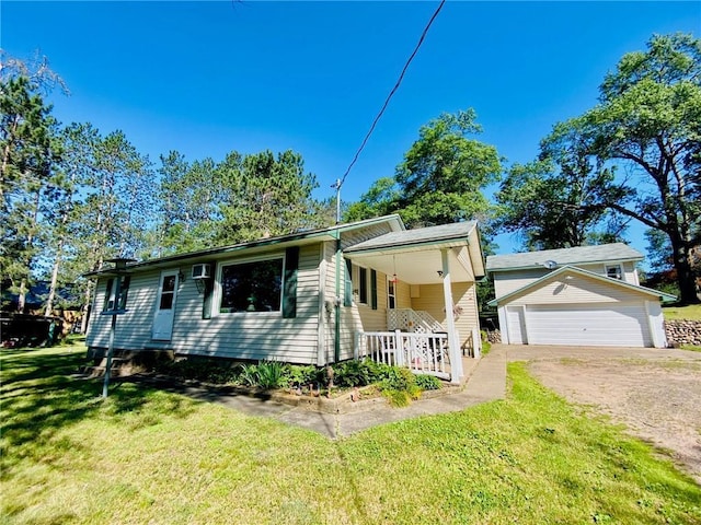 view of front facade featuring a garage, a porch, an outdoor structure, and a front yard