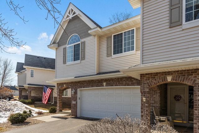 view of front of home featuring brick siding and an attached garage