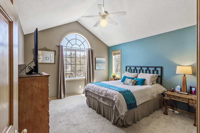 bedroom with lofted ceiling, a ceiling fan, a textured ceiling, carpet flooring, and baseboards