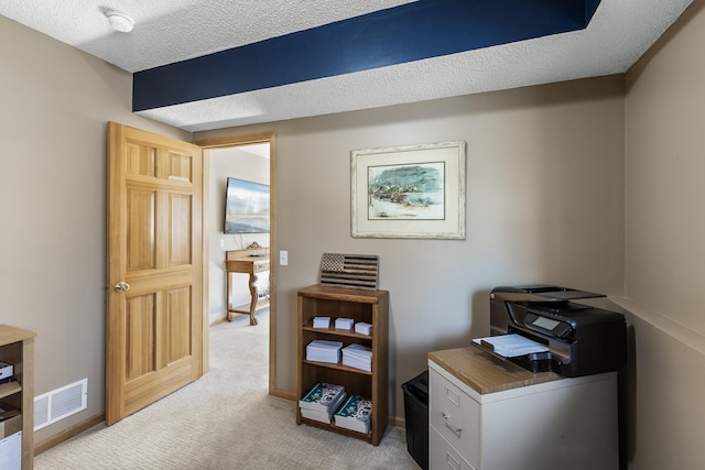 office area with visible vents, baseboards, light colored carpet, and a textured ceiling