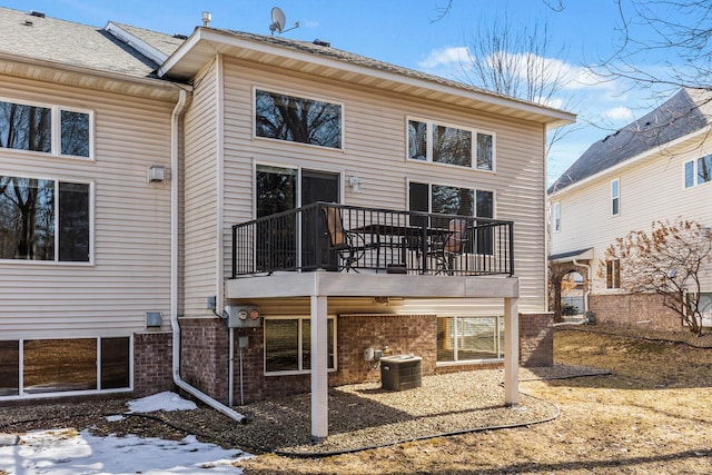 back of property featuring brick siding and central air condition unit