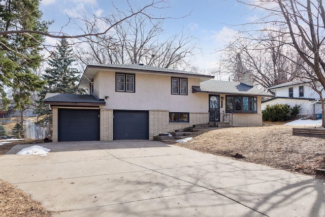 split level home with stucco siding, brick siding, driveway, and a chimney