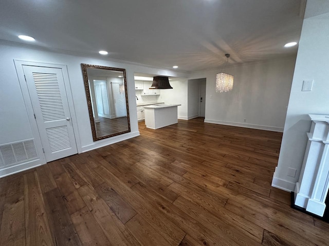 unfurnished living room featuring visible vents, baseboards, dark wood finished floors, recessed lighting, and an inviting chandelier