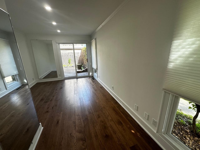 unfurnished room featuring visible vents, crown molding, baseboards, recessed lighting, and dark wood-style floors